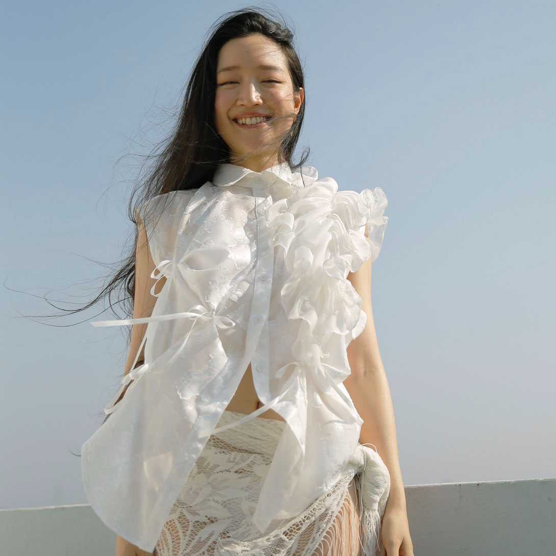 Rotsaniyom Sleeveless white shirt with Ruffle detail