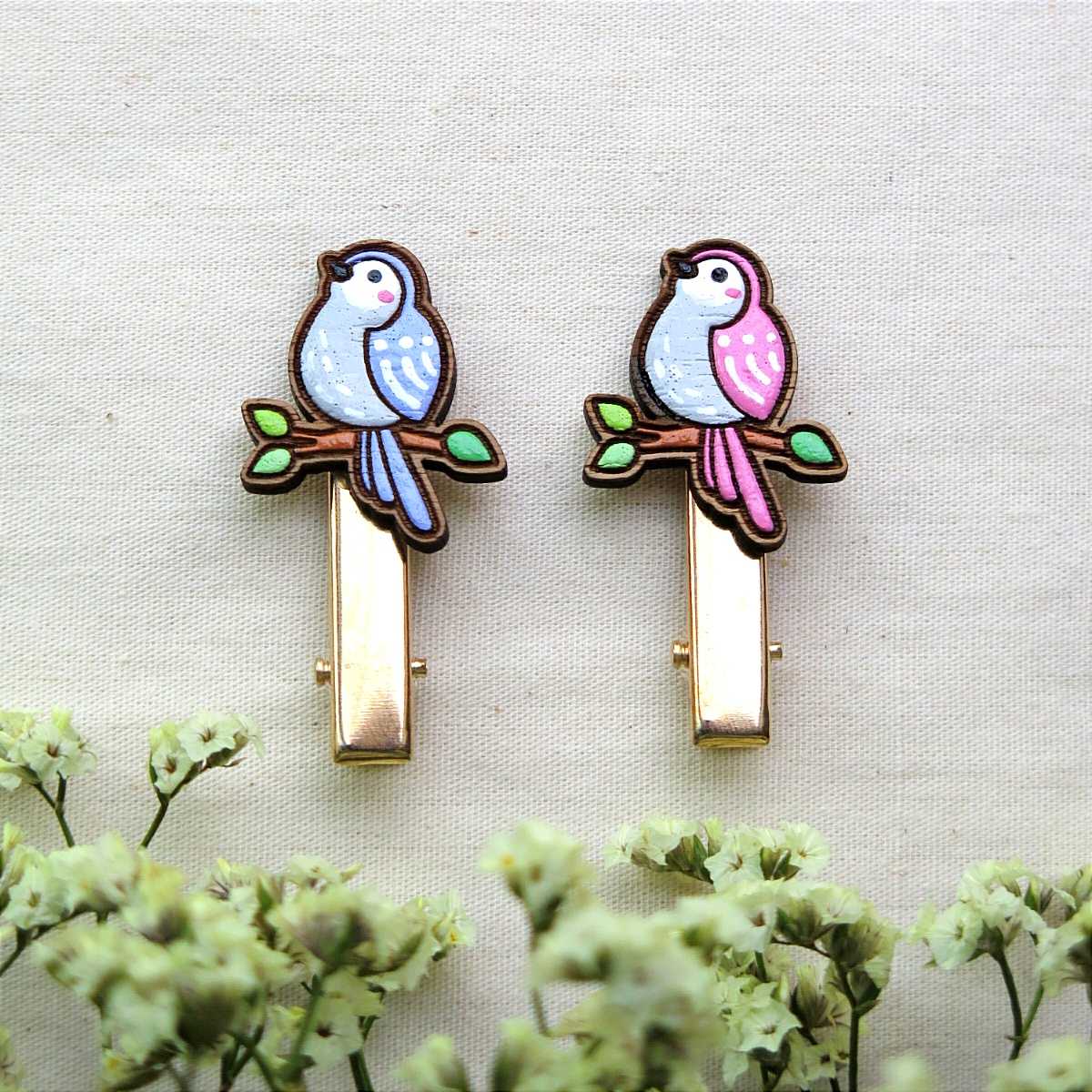 Wooden hair clip bird perched on branch